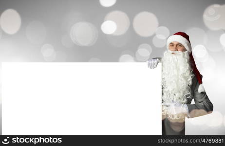 Santa with banner. Businessman in santa hat with white blank banner