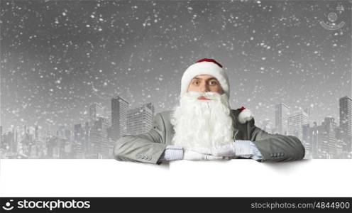 Santa with banner. Businessman in santa hat with white blank banner