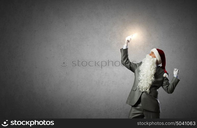 Santa with mobile phone. businessman in santa hat looking in mobile phone