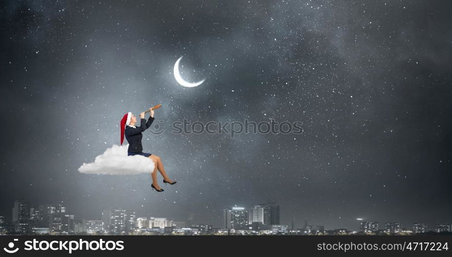 Santa woman in search. Businesswoman in Santa hat on cloud in sky looking in spyglass