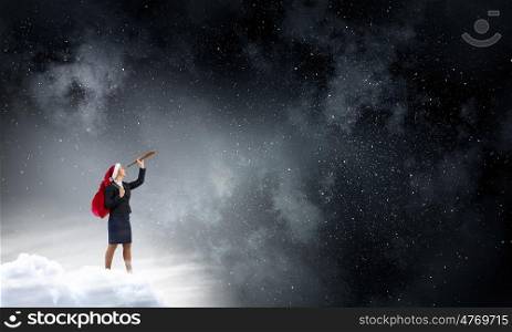 Santa woman in search. Businesswoman in Santa hat on cloud in sky looking in spyglass