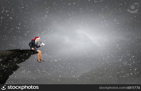 Santa woman making announcement. Santa businesswoman sitting on rock top and shouting into megaphone