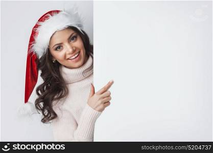 Santa woman pointing at blank whiteboard. Santa woman pointing at blank whiteboard with copy space isolated on white background