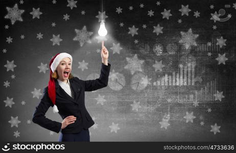 Santa woman. Santa woman pointing on light bulb with finger