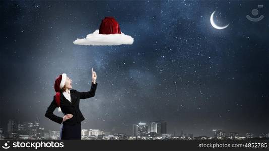 Santa woman. Santa woman pointing up on red bag with finger