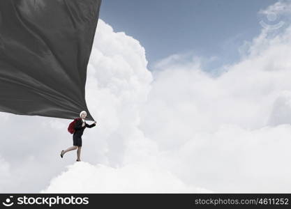 Santa woman with sack. Young businesswoman carrying big heavy Christmas sack on back and clothing banner