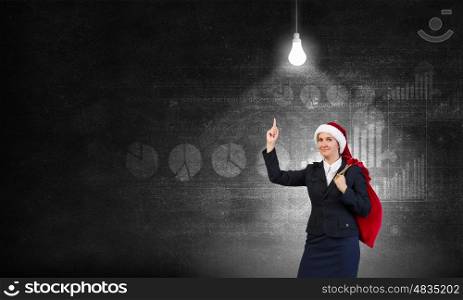 Santa woman with sack. Young businesswoman carrying big heavy Christmas sack on back
