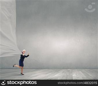 Santa woman with white banner. Young Santa businesswoman pulling white clothing banner