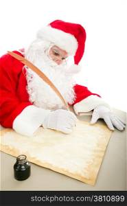 Santa writing his Christmas list on parchment paper with a quill pen and ink.