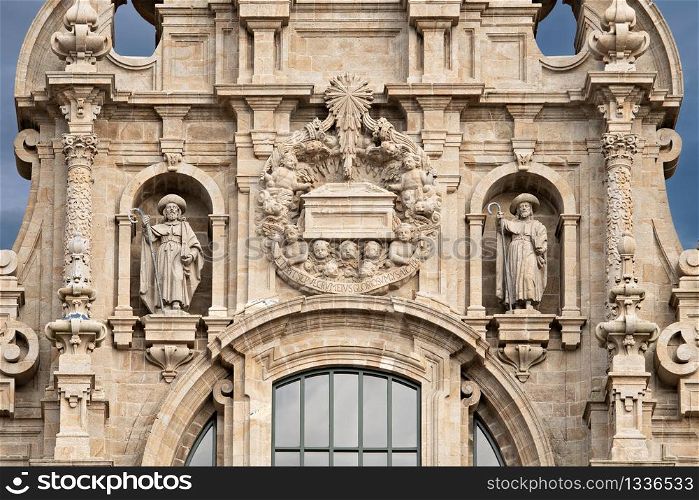 Santiago de Compostela cathedral facade detail with two sculptures of Saint James and the tomb. Baroque facade detail. Ancient architecture