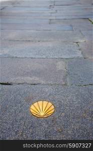 Santiago de Compostela end of Saint James Way golden shell sign on soil in Galicia Spain