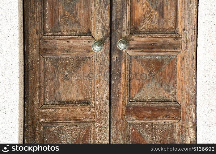 santo antonino abstract samarate rusty brass brown knocker in a door curch closed wood lombardy italy varese