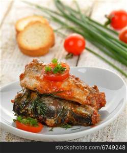 Sardines In Tomato Sauce In A White Dish
