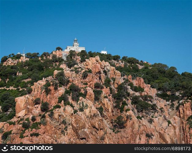Sardinia Coastline: White Lighthouse Tower on Rocks and Cliffs near Sea, Italy
