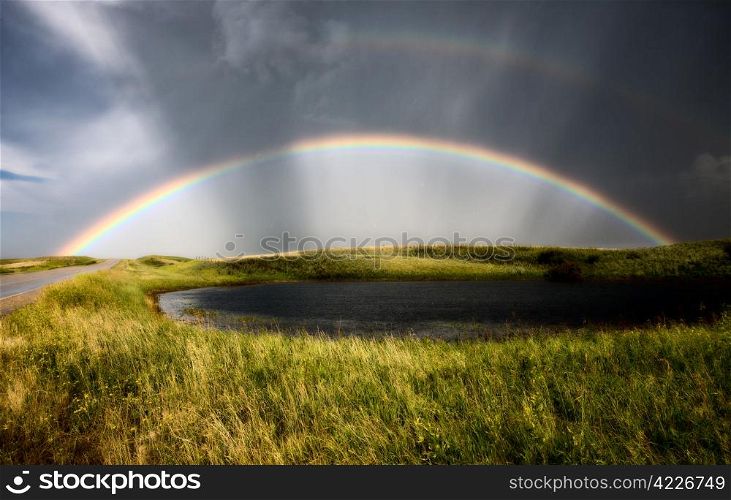 Saskatchewan Storm Rainbow overfield and slough pond hail