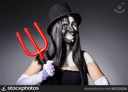 Satana woman with pitchfork and facemask