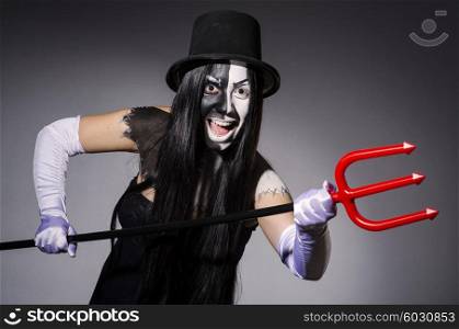 Satana woman with pitchfork and facemask