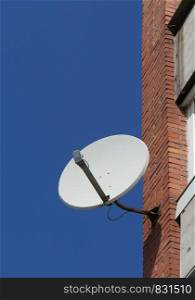 satellite antenna on the wall of the house