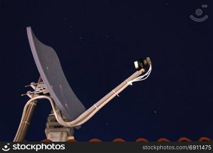 satellite dish receiver with a night starred sky