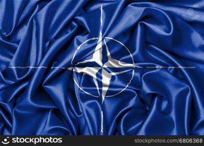 Satin flag with emblem, NATO symbol close-up