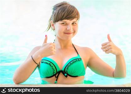 satisfied and happy young woman in the pool