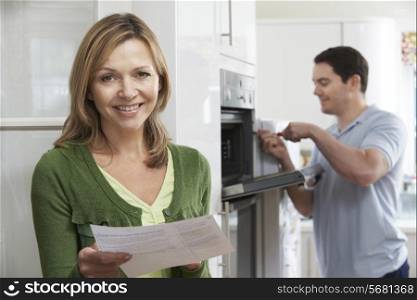 Satisfied Female Customer With Oven Repair Bill