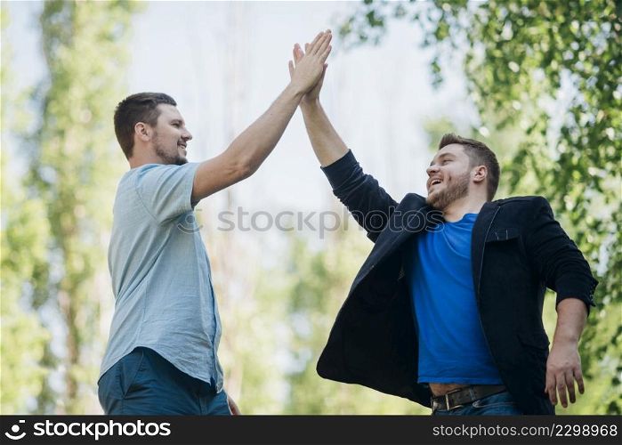 satisfied friends giving high five