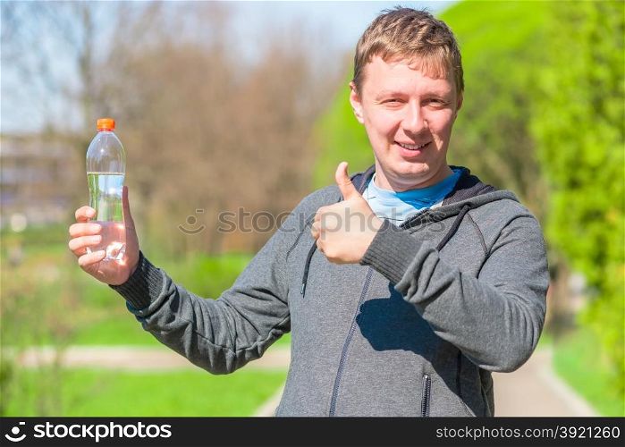 satisfied man with a bottle of drinking water