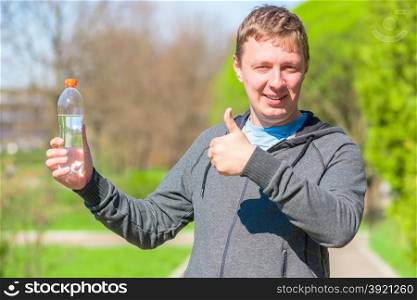 satisfied man with a bottle of drinking water