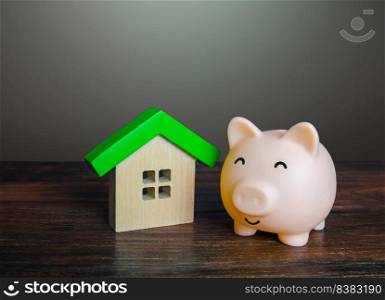 Satisfied piggy bank near the house. Low cost utilities and high energy efficiency. Housing green technologies. Autonomy and self-sufficiency. Economical affordable housing.