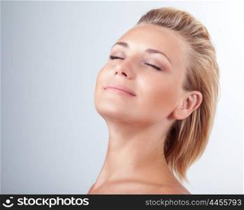 Satisfied woman at spa, portrait of beautiful female with closed eyes of pleasure over light background, natural cosmetics, enjoying day at spa salon