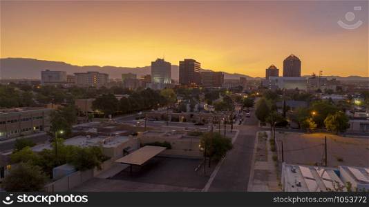 Saturated orange hue appears behind Albuquerque New Mexico at sunrise