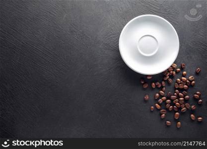 Saucer with beans on black textured background. Saucer with beans on dark background