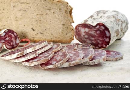 saucisson and bread in front of white background