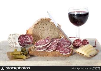 saucisson, bread and butter in front of white background