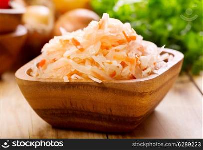 sauerkraut in a bowl on wooden table