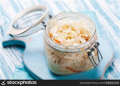 sauerkraut in a glass jar on the table