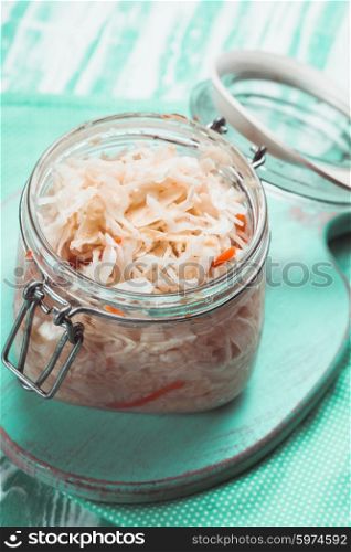 sauerkraut in a glass jar on the table. sauerkraut
