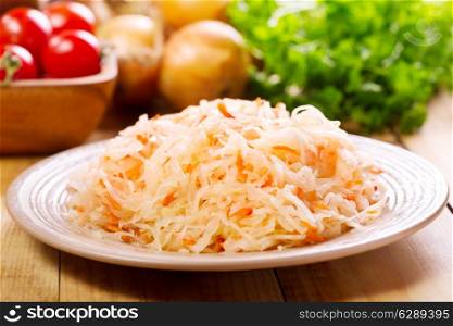 sauerkraut in a plate on wooden table