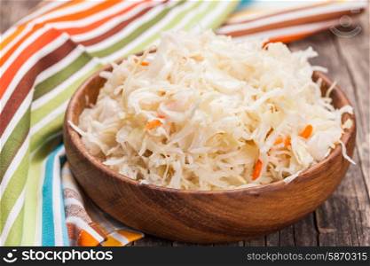sauerkraut in a wooden bowl on the table. sauerkraut