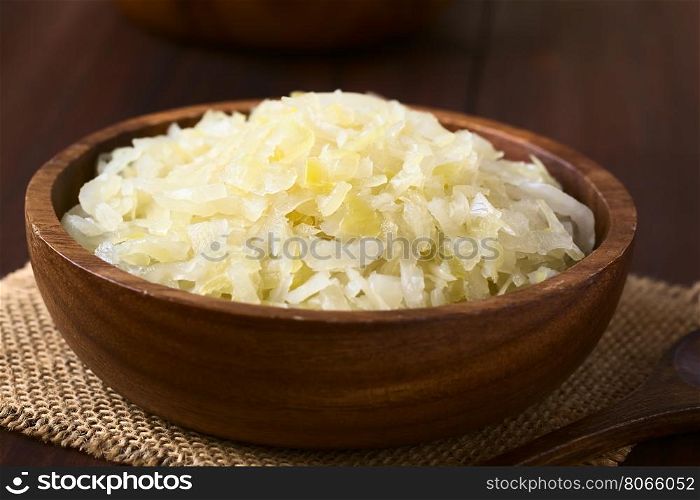 Sauerkraut in wooden bowl, photographed with natural light (Selective Focus, Focus one third into the sauerkraut)
