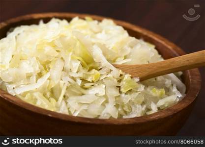 Sauerkraut in wooden bowl, photographed with natural light (Selective Focus, Focus one third into the sauerkraut)