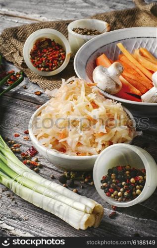 sauerkraut on rustic recipe. sauerkraut with spices and carrots in a wooden tub