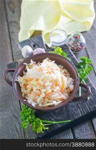 sauerkraut salad in the bowl and on a table