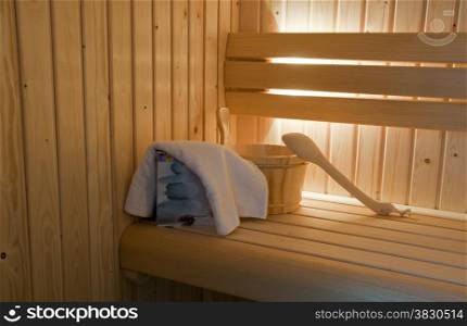 sauna interior with bucket and towels