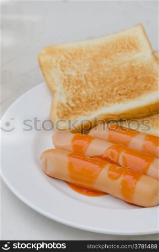 sausage and toast. sausage with sauce and toast bread on a plate