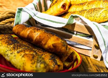 Sausage in puff pastry on a rustic table. Tasty hot dog in pastry