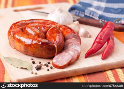 sausage on a wooden cutting board.