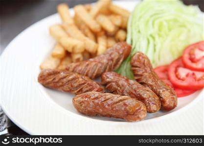 Sausage with potato on wood background