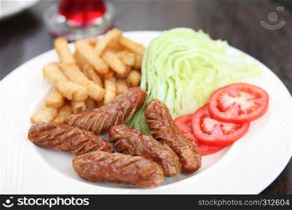 Sausage with potato on wood background